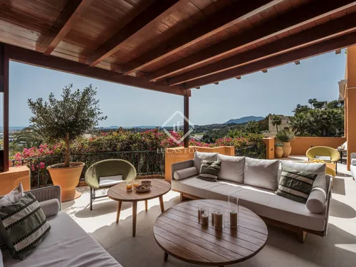 Artfully renovated 4-bedroom, 4.5-bathroom apartment in exclusive Les Belvederes, Nueva Andalucía with panoramic sea views, designer interiors and luxury amenities.